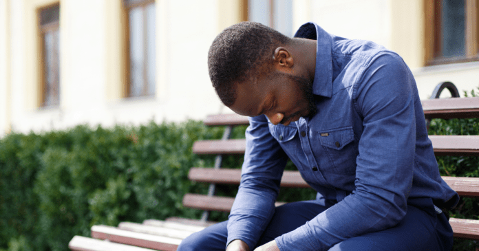 Sad man sitting on a bench