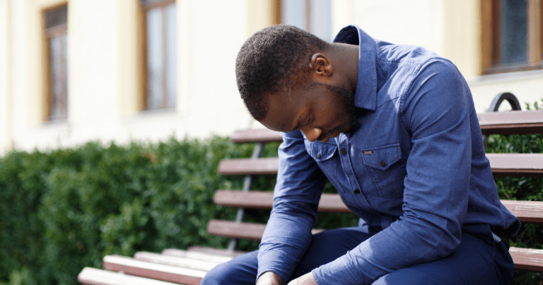 Sad man sitting on a bench
