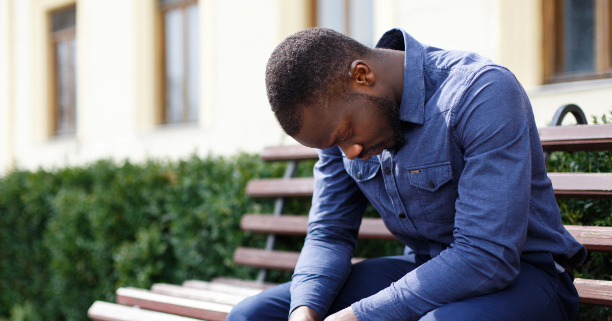 Sad man sitting on a bench