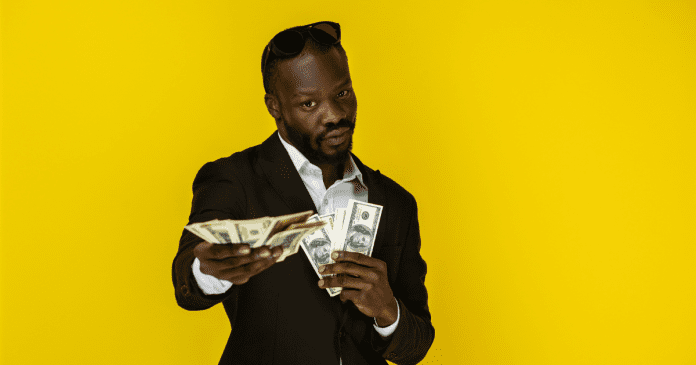 Black man holding a lot of money