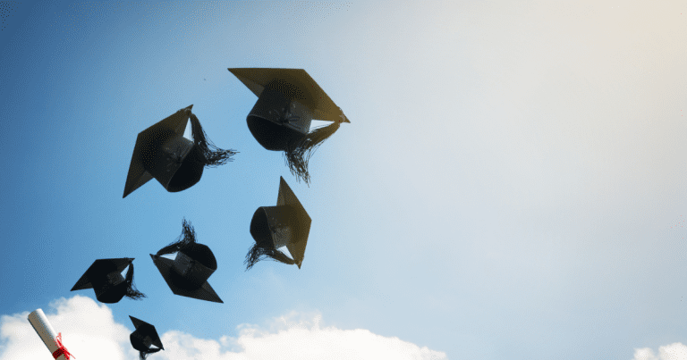 large-graduates-hands-throwing-graduation-hats