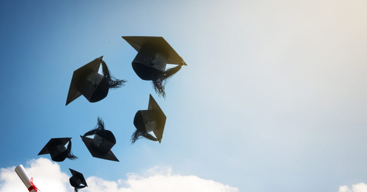 large-graduates-hands-throwing-graduation-hats