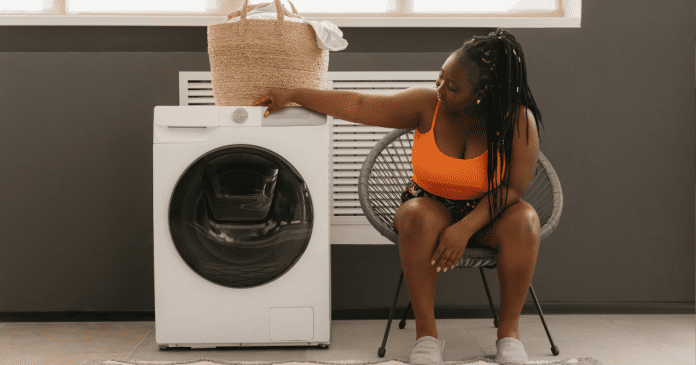 Woman looking at her washing machine.