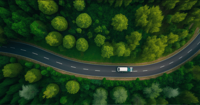 The aerial top view of road among the forest with .
