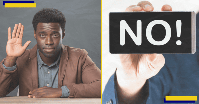 One confident African businessman sitting at a desk, right frame shows a NO word on a mobile phone.