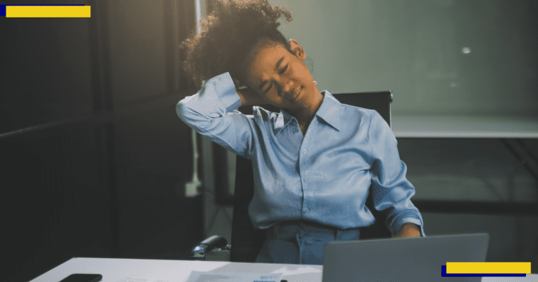 A woman working hard in the office having aches and pains.