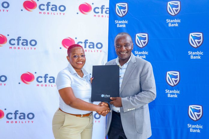 Alice Mwaniki, Head of Personal Banking at Stanbic Bank Kenya (L), alongside Daniel Maundu, General Manager, National Sales at CFAO Mobility Kenya (R), during the signing of an MOU at the Beauty Behind the Bonnet event held at the CFAO showroom.